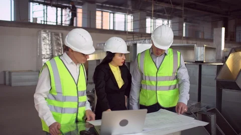Engineer and client looking on project on the construction site. 4 k Stock Footage 85823339