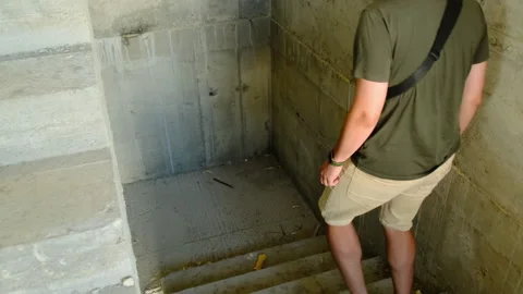 Engineer and colleague walk down steps of unfinished building 스톡 동영상 317608720