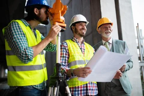 Engineer and construction site manager dealing with blueprints and plans Stock-Fotos