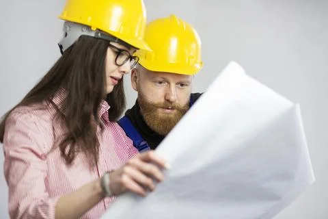 Engineer and construction worker looking at plan Stock Photos