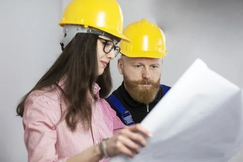 Engineer and construction worker looking at plan Stock Photos