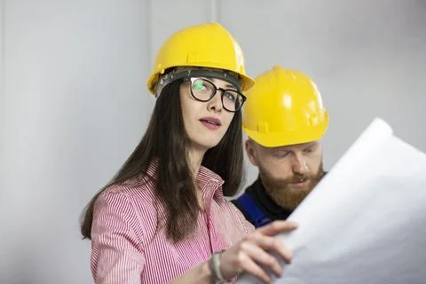 Engineer and construction worker looking at plan Stock Photos
