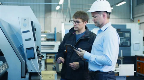 Engineer and Factory Worker are Setting Up CNC Lathe Machine on Factory 스톡 동영상 52321171