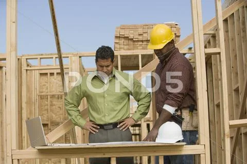 Engineer And Foreman Discussing Plans Stock Photos