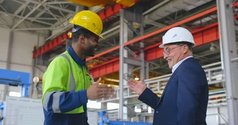 Engineer and foreman give shandshake and hifh five to each other. Good teamwork Stock Footage 121099678