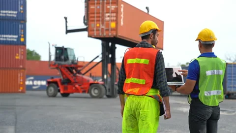 Engineer and foreman using laptop computer check Container Stock Footage 132549613