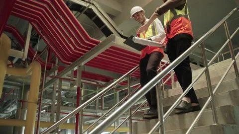 The engineer and the foreman were talking and walking down the stairs Stock Footage 150862791