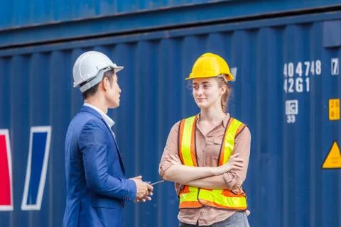 Engineer and foreman worker checking containers box at cargo, Logistic concept Фото