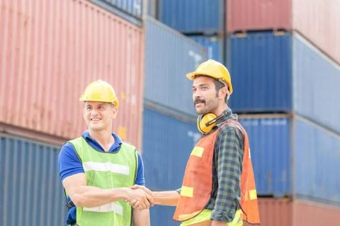 Engineer and foreman worker handshake with blurred construction site, Success 写真素材
