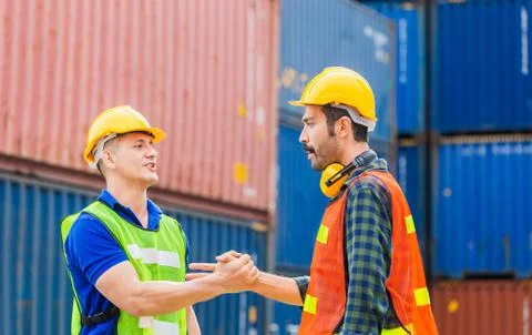 Engineer and foreman worker handshake with blurred construction site, Success Photos