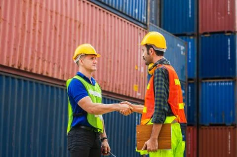 Engineer and foreman worker handshake with blurred construction site Stockfoto's