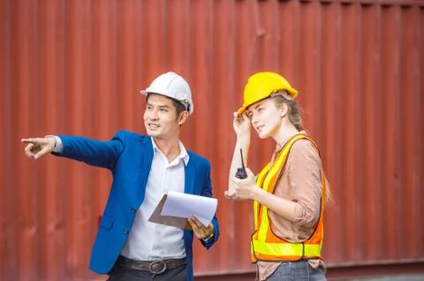 Engineer and foreman worker team checking containers box from cargo Stockfoto's