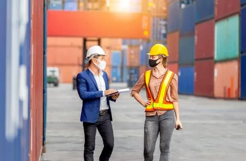 Engineer and foreman worker team checking containers box from cargo 写真素材