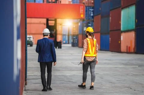 Engineer and foreman worker team checking containers box from cargo 写真素材