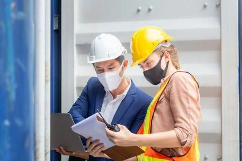 Engineer and Foreman worker team checking containers box from cargo Stockfoto's