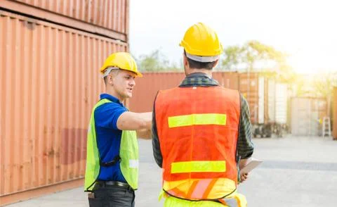 Engineer and foreman worker team checking containers box from cargo Fotos Stock