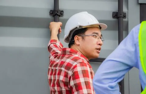 Engineer and foreman worker team checking containers box from cargo Fotos de archivo