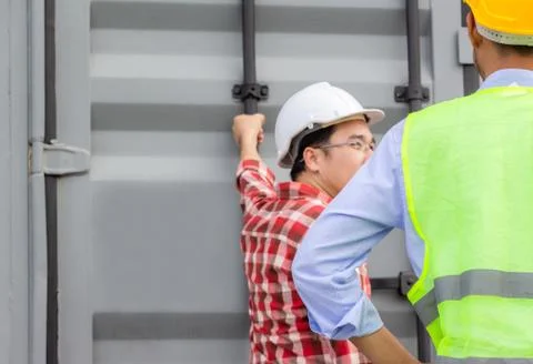 Engineer and foreman worker team checking containers box from cargo Fotos Stock