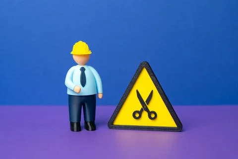 Engineer and the scissors symbol. Cutting the project budget. Concept of st.. Stock Photos