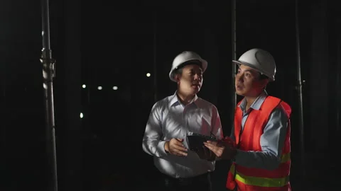 Engineer and supervisor construction using tablet inspect on a house at night. Stock-Footage 175683773