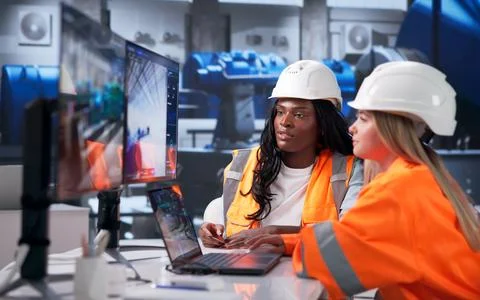 Engineer And Technician Discuss Digital 3D Design Details On Laptop Together. Stock Photos