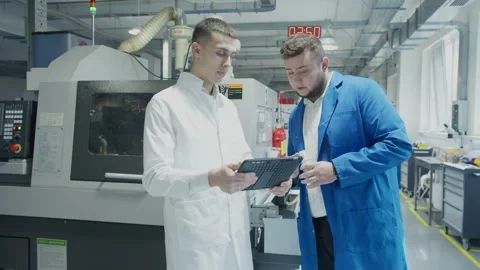 Engineer and technician discussing production process at factory Stock-Footage 152448757