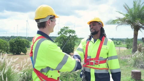 Engineer and technician discussing a solution problem of wind turbine Stock Footage 253982148