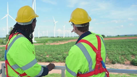 Engineer and technician discussing a solution problem of wind turbine Stock Footage 253989369