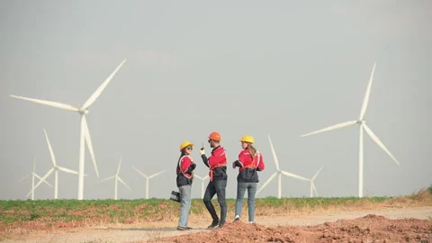 Engineer and technician greet each other in wind turbine farm Stock Footage 264138530
