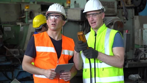 Engineer and technician manager talking together with tablet  controlling b.. Stock Footage 246987386