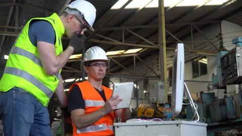 Engineer and technician manager talking together with computer checking lis.. Stock Footage 246987428