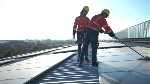 Engineer and technician working on the solar panel on the warehouse Stock Footage 260235701