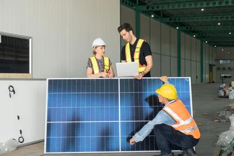 Engineer and technician working with solar panel in warehouse. Foto stock