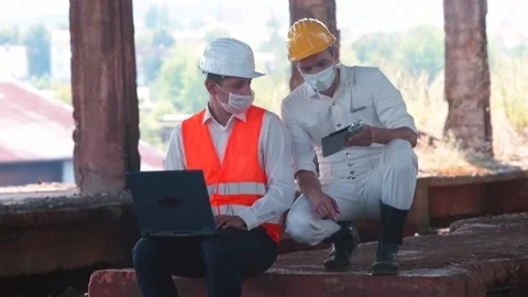 An engineer and worker discussing safety rules for working at construction site Stock Footage 137806469