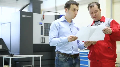 Engineer and worker discussing a work project Stock Footage 62970603