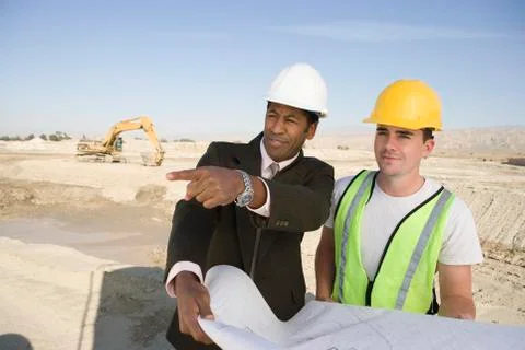 Engineer And Worker In Discussion At Site Stock Photos