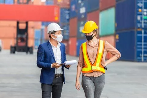 Engineer and worker team checking containers box from cargo, teamwork concept Fotos de archivo