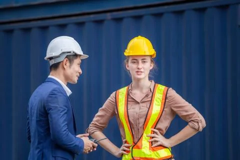 Engineer and worker team checking containers box, foreman in hardhat Stockfoto's