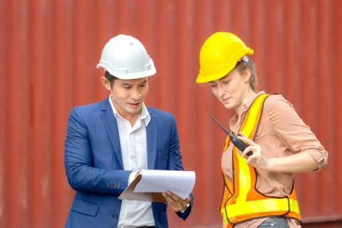 Engineer and worker team checking containers box from cargo Stock Photos