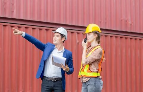 Engineer and worker team checking containers box from cargo, Woman foreman in Stockfoto's