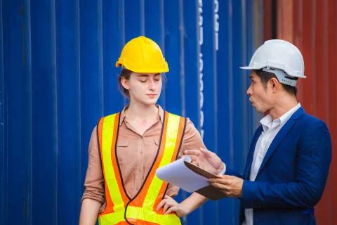Engineer and worker team checking containers box from cargo, Logistic concept Фото