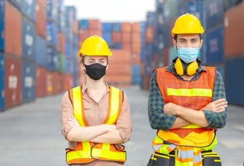 Engineer and worker team wearing protection face mask with arms crossed Photos