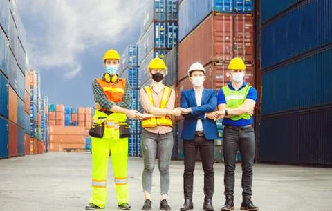 Engineer and worker team wearing protection face mask with arms crossed 写真素材