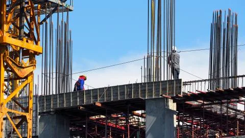 Engineer and workers on high building construction site. Fotos de archivo