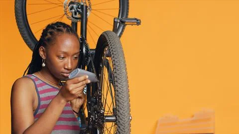 Engineer applying adhesive on bike components during maintenance process Stock Photos