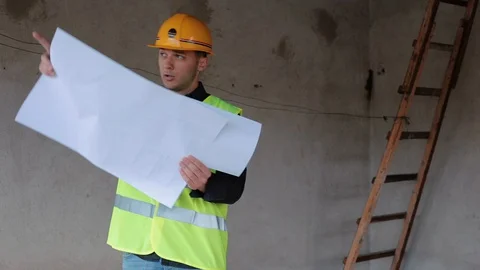 Engineer Architect ,checking blueprints for a new House Stock-Footage 129442578