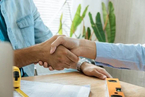Engineer, architect, construction worker team hands shaking Stock Photos