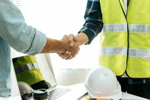 Engineer, architect, construction worker team hands shaking Stock Photos