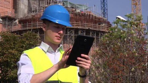 Engineer architect contractor sliding tablet computer touchpad smiling cheerful Stock Footage 79622663