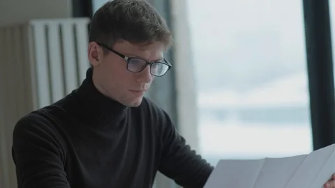 Engineer-architect holds blueprint, studying a document, takes notes Vídeo Stock 125011326